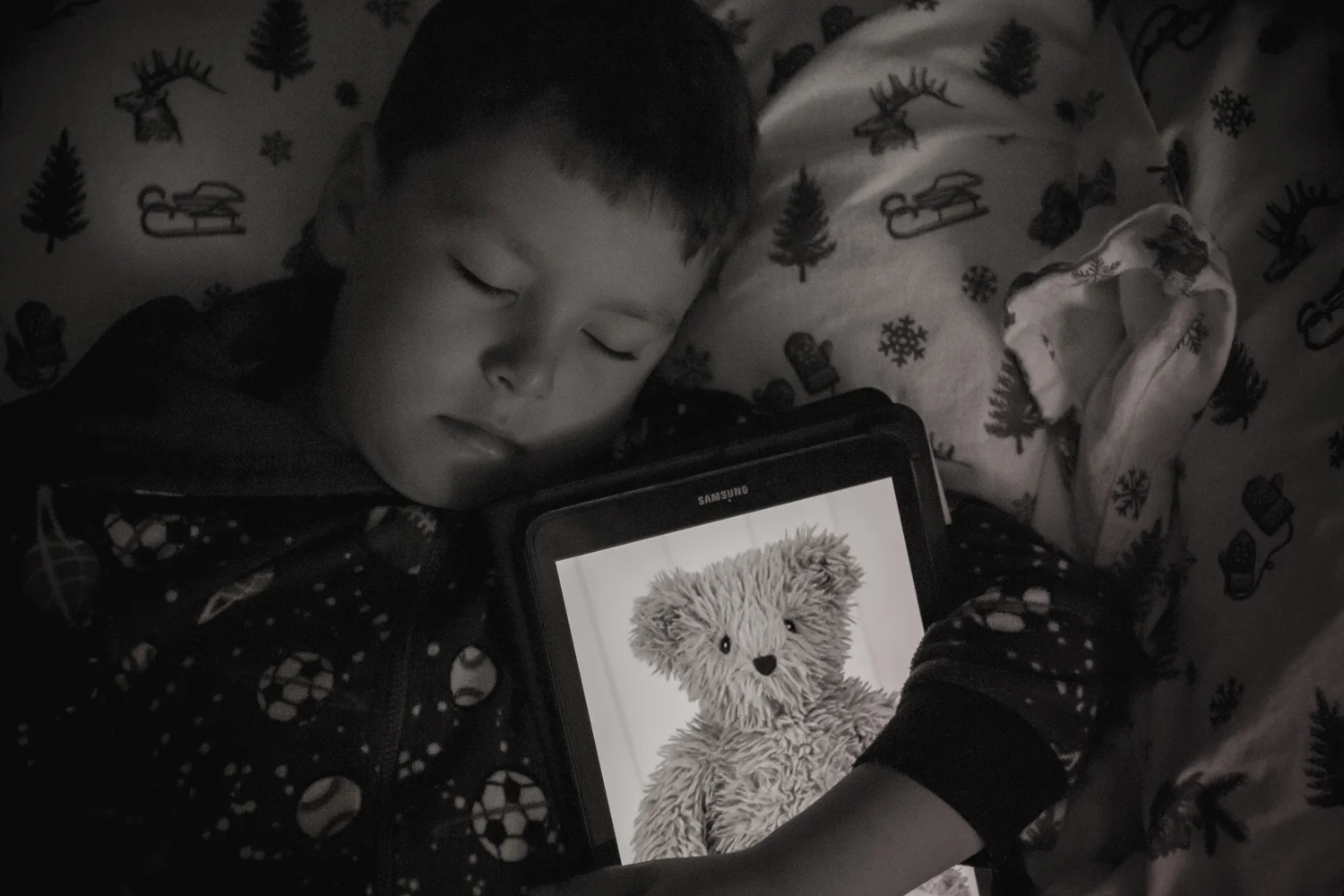 Luke with a teddy bear on a tablet