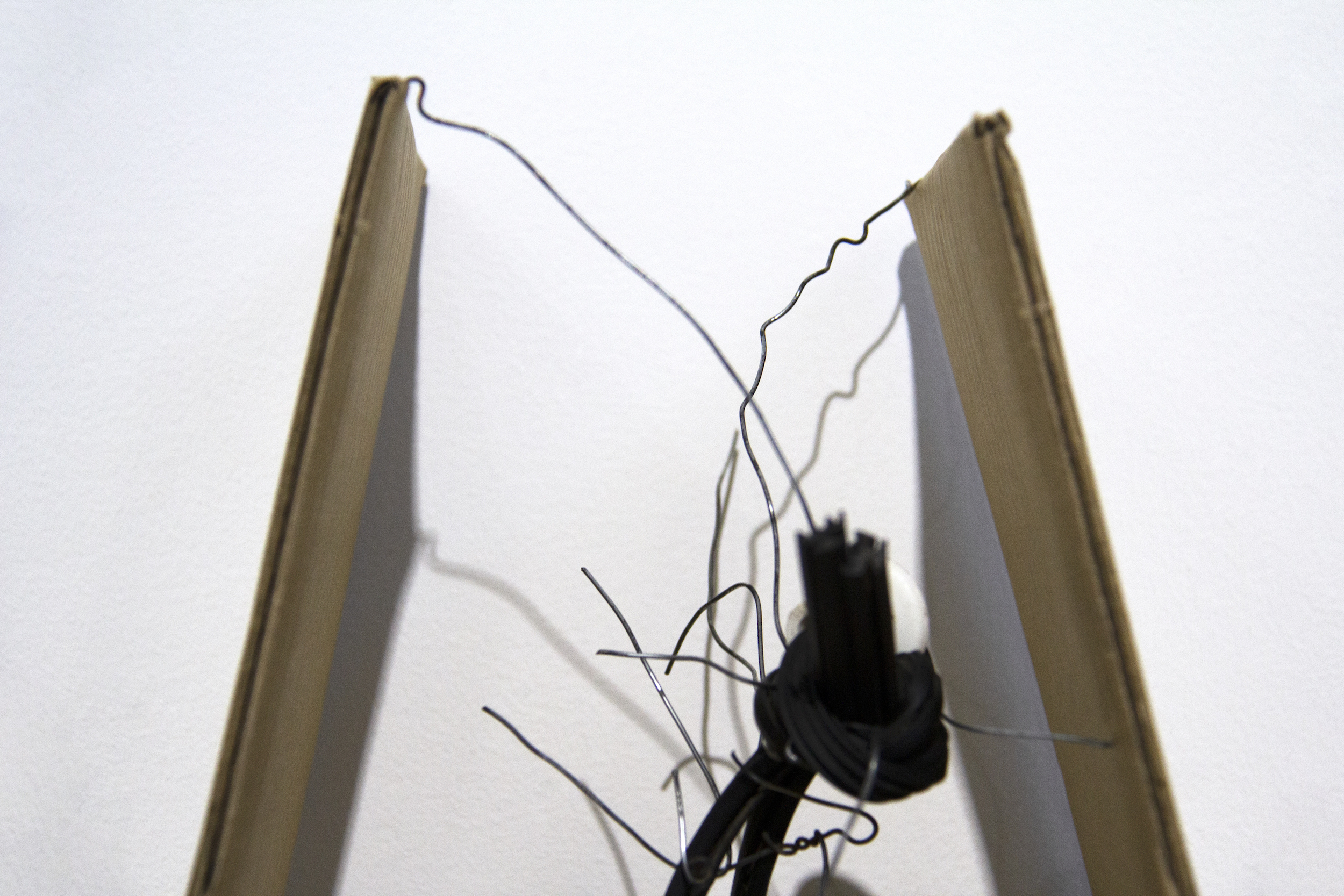    The cradle   (detail)  Used wire from funeral tent and cardboard packaging; found wooden structure, rubber tubing, plastic knob; and acrylic paint  Approx. 17 6/8 x 12 6/8 x 16 1/2 inches  2019 