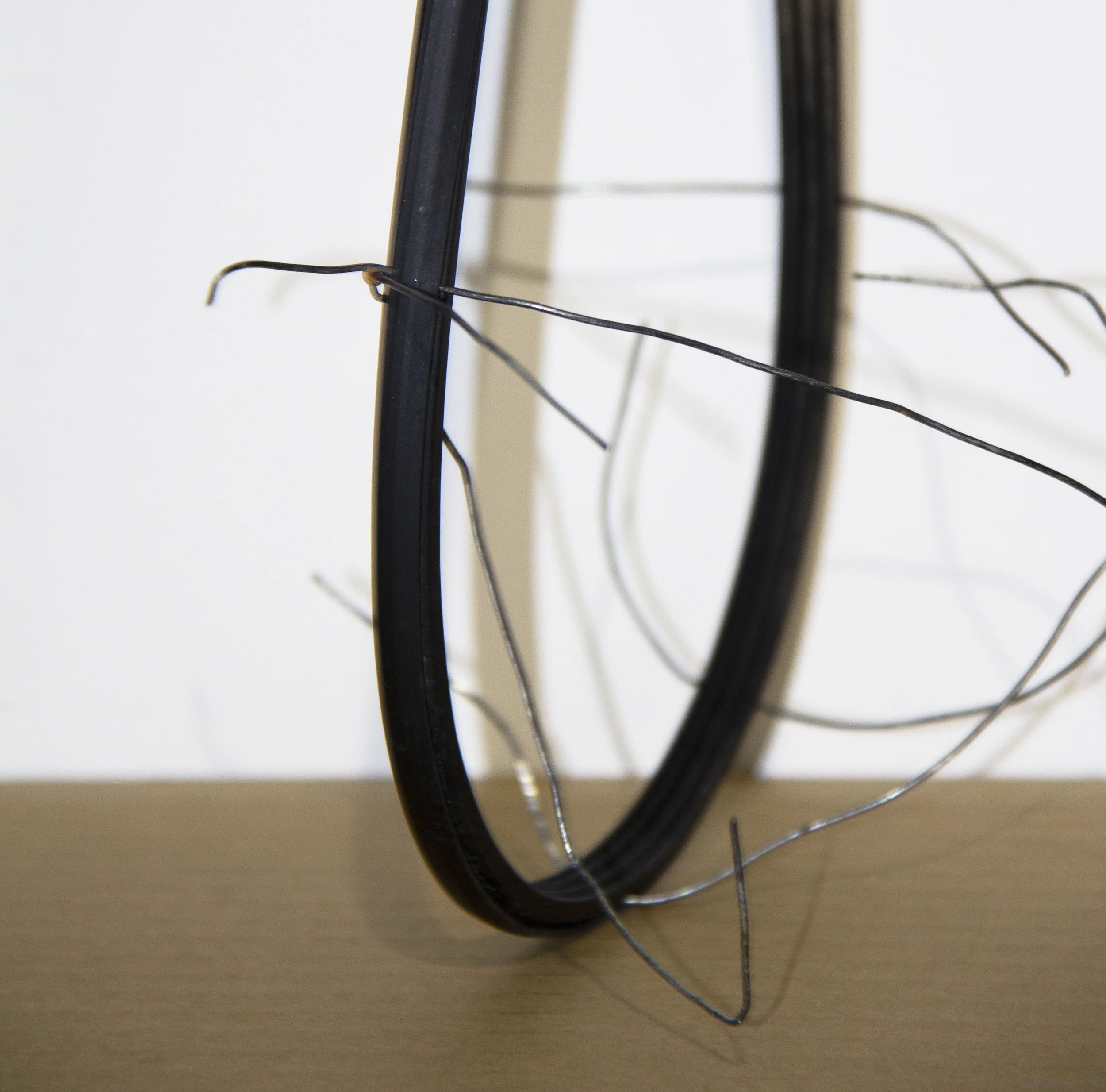 The cradle (detail) Used wire from funeral tent and cardboard packaging; found wooden structure, rubber tubing, plastic knob; and acrylic paint Approx. 17 6/8 x 12 6/8 x 16 1/2 inches 2019