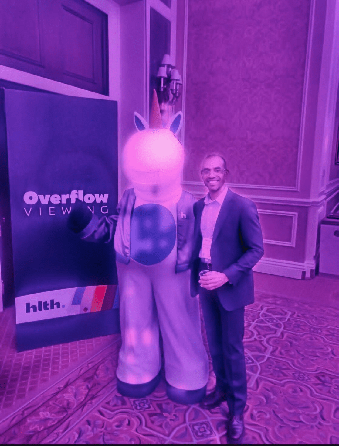 Faisal and mascot at HLTH.png