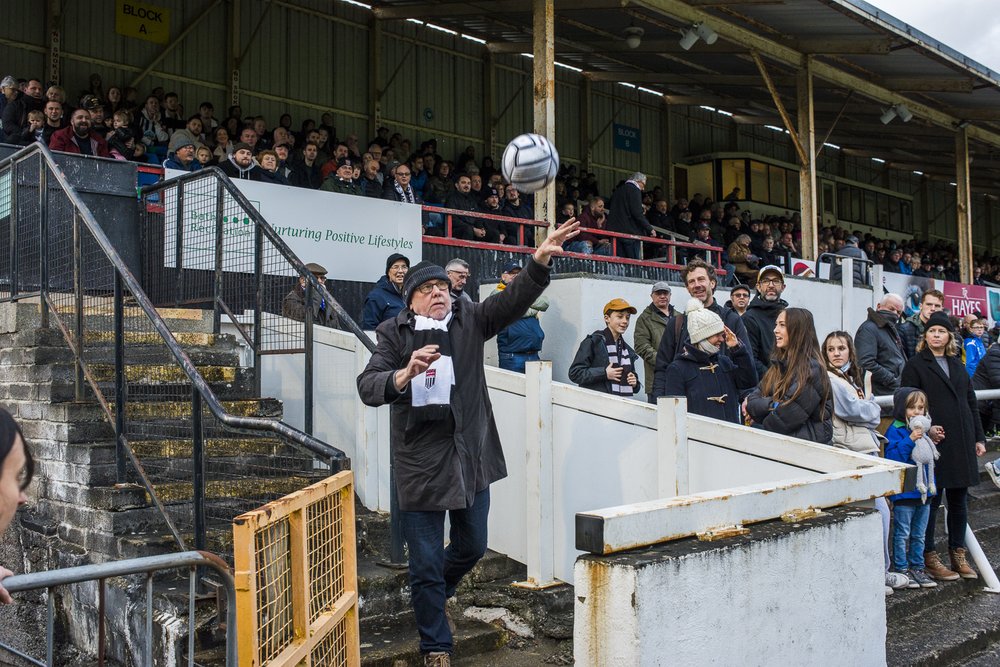 Returning the match ball.