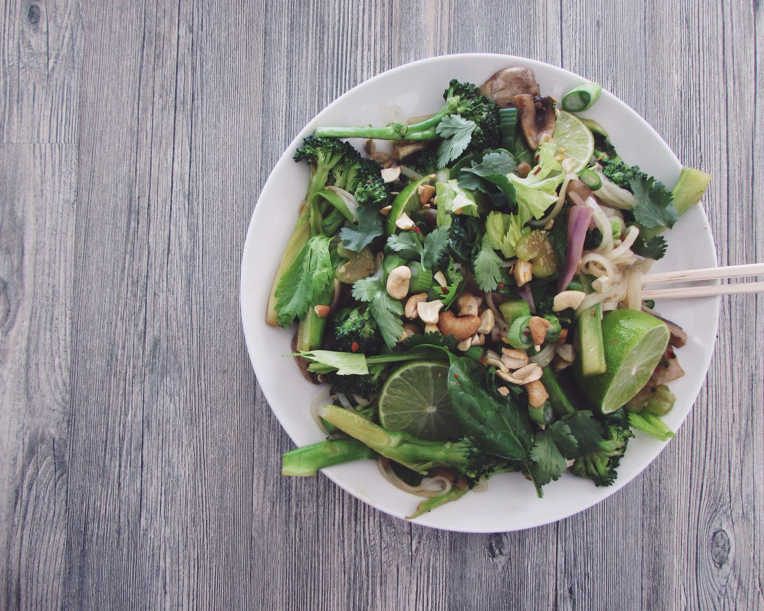 green stir fry with rice noodles