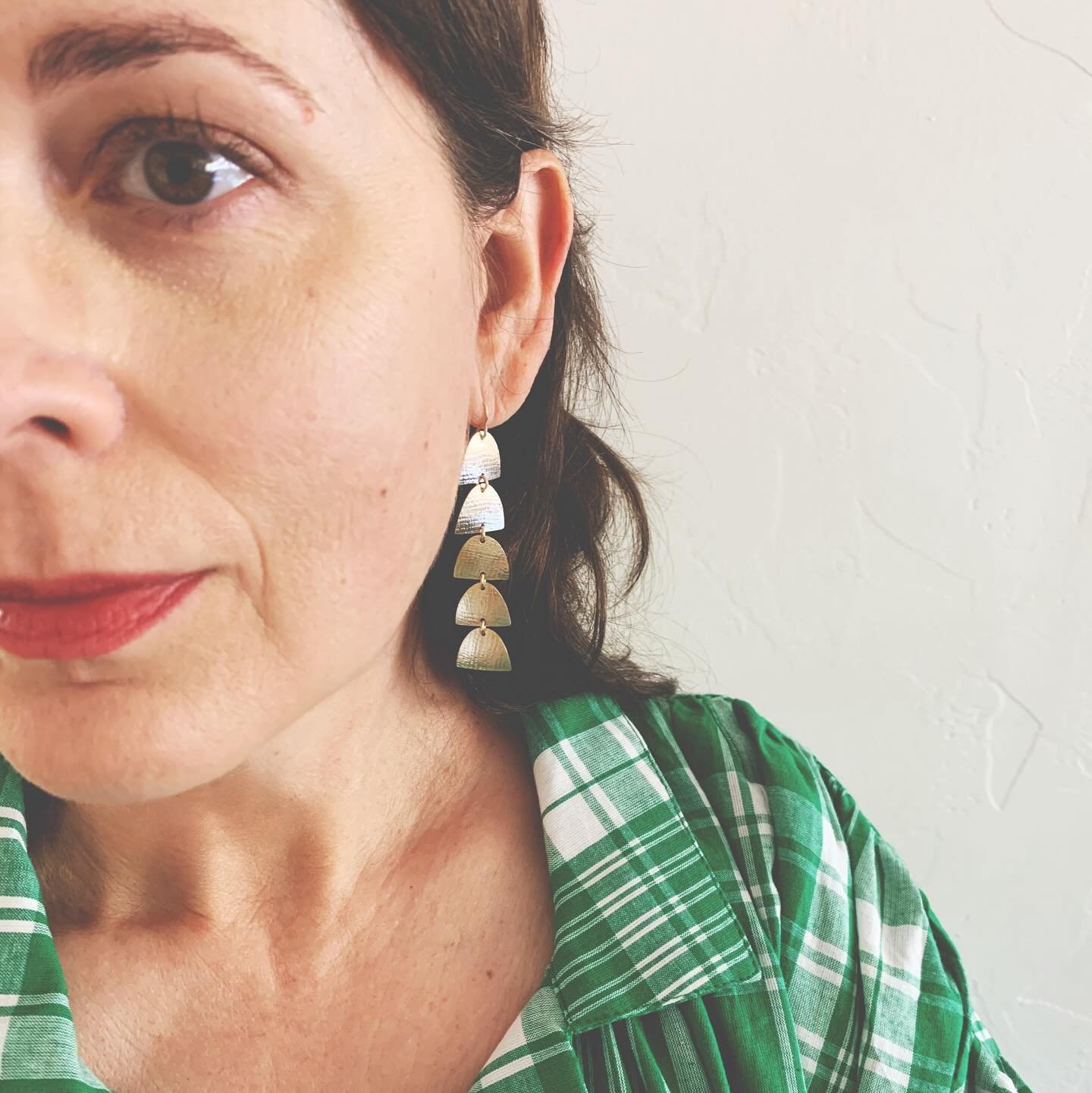 Portrait of a middle aged woman wearing a voluminous kaftan and the Chime Earrings - perfect for summer and aging ear lobes (so lightweight). In 14K gold filled for sparkle and shine. 🌟