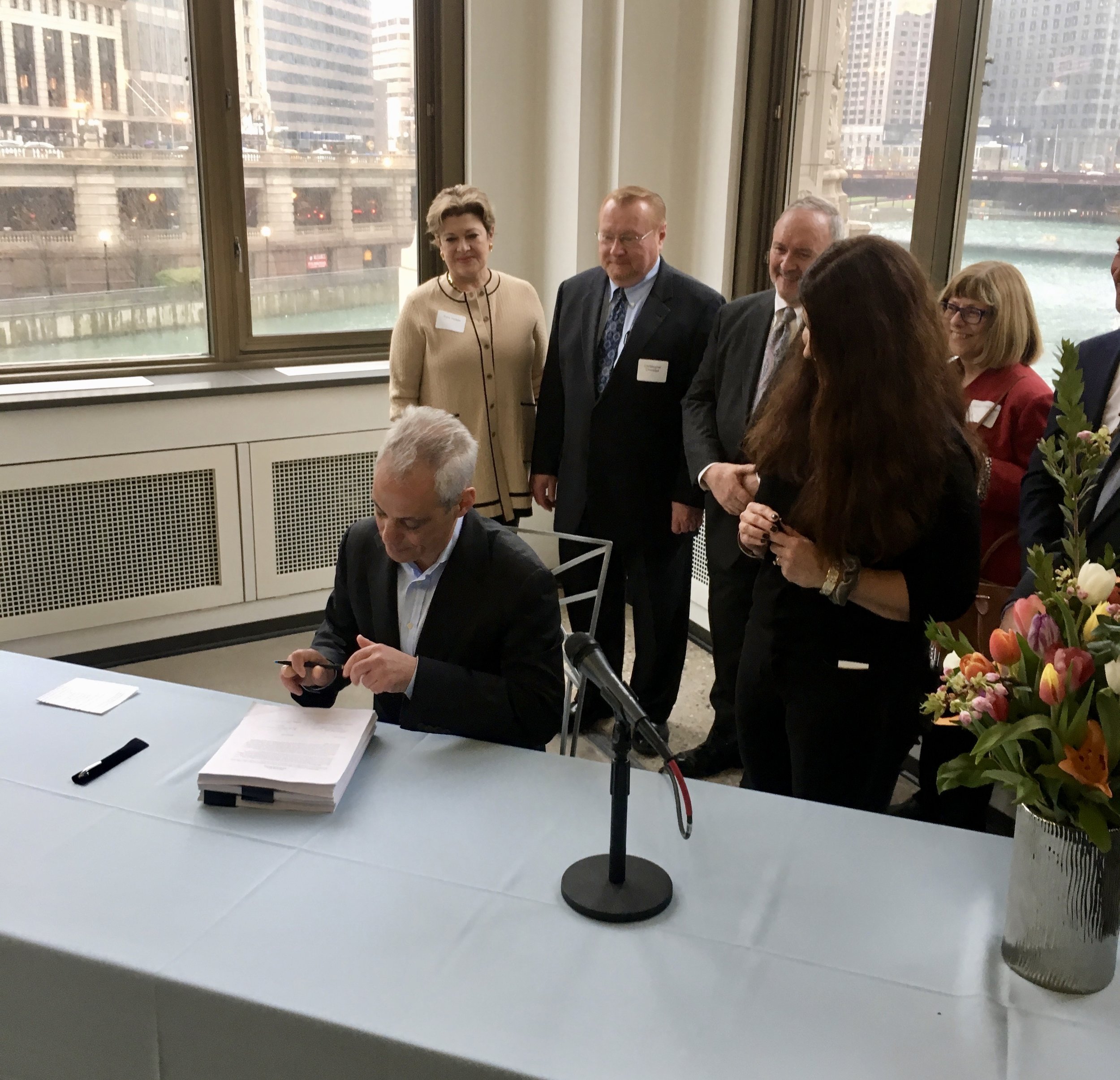 Commissioner Judy Frydland overlooks Mayor Rahm Emanuel ceremoniously signs the updated building code legislation. Photo by Steven Vance