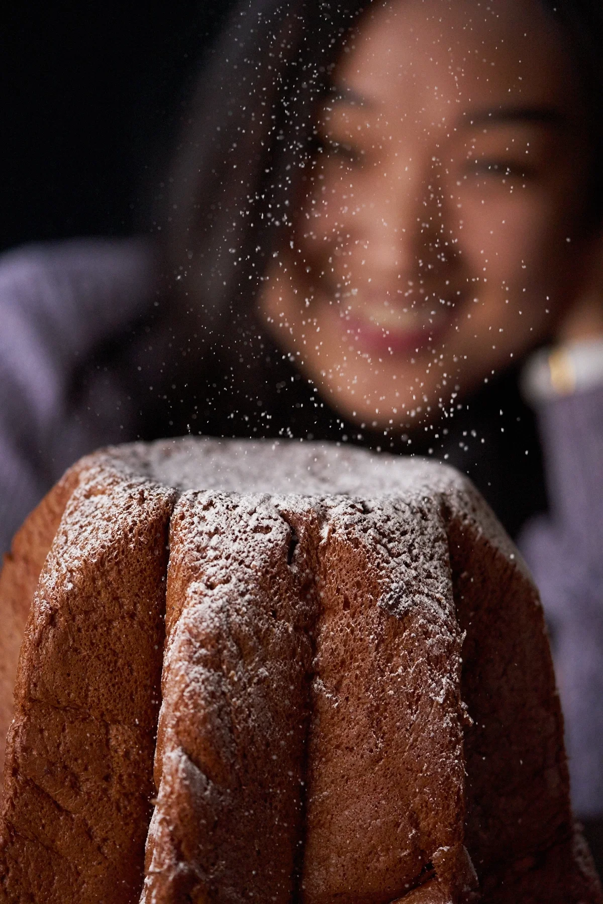 Our Digital Retoucher, Sasha, indulges in the Italian sweet bread, Pandoro. The treat is dusted with powdered sugar, which made us wish for snow.