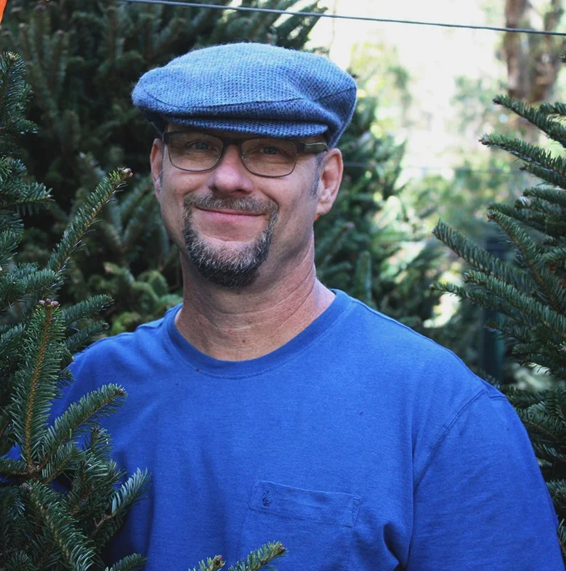 Brian Bryson Brian Bryson started working at Native Nurseries in 1991. He is a talented landscape artist, and most of the drawings in our newsletter are his. We sell prints of his many bird and seashore/boat watercolors here at the nursery. Brian also painted the mural in the Children’s Nature Nook and the various signs in the store. The cardinal on our new street sign is a reproduction of Brian’s artwork. Brian also designs and install water features. Check out some of the ponds he’s designed and installed for our customers. He’s a member of the retail staff and is currently being trained by Jody in landscape design. In his spare time, Brian enjoys making blackberry jam and sailing and (like Jody) built his own sailboat.