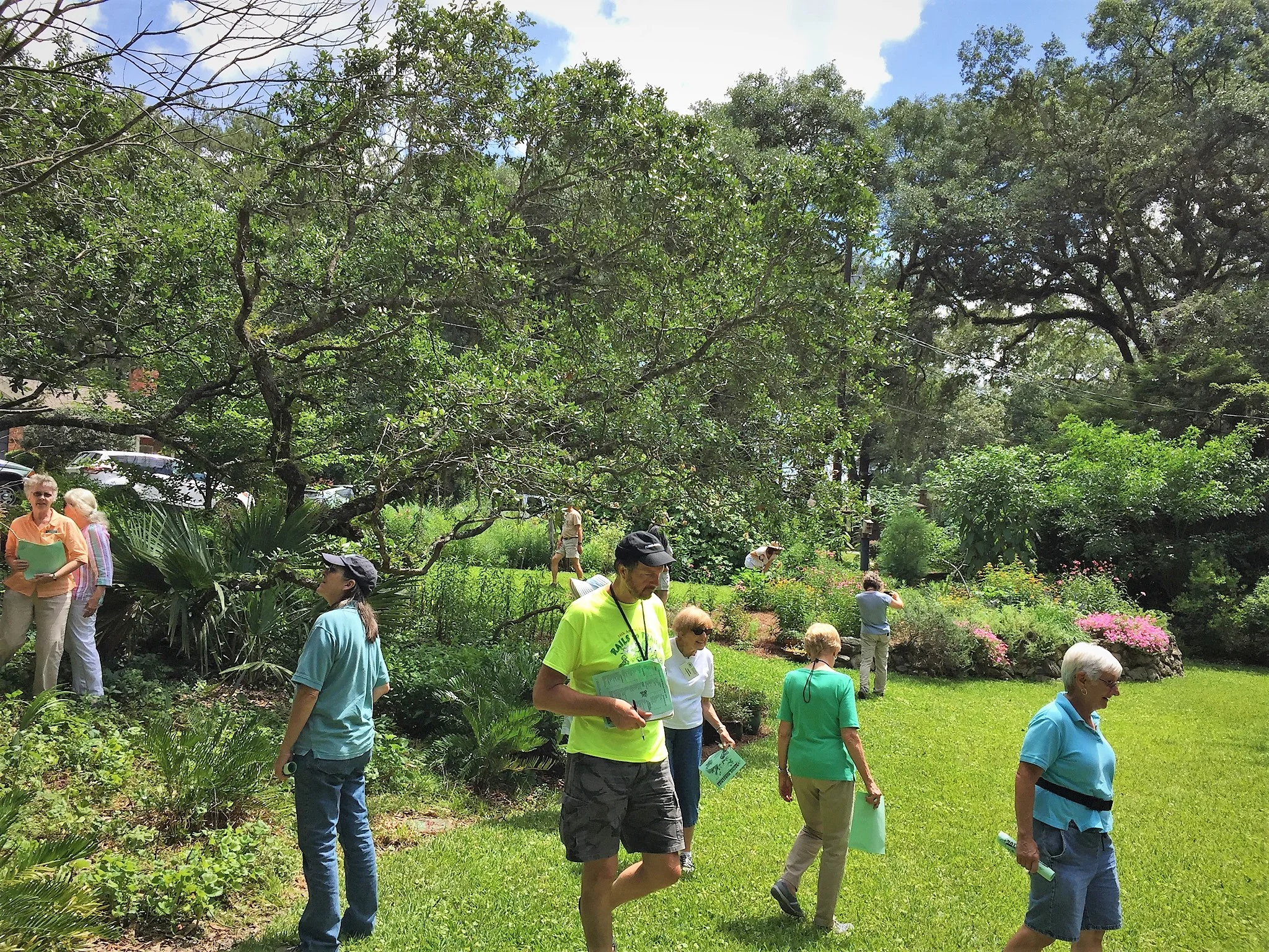 Florida Native Plant Society members examine the large mulched and planted beds that slow down the flow of rainwater in Legare’s front yard. Photo by Jody Walthall.
