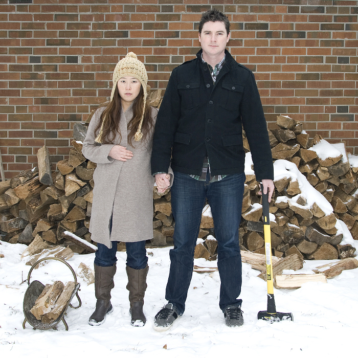 Canadian Couple with Ax and Wood Pile