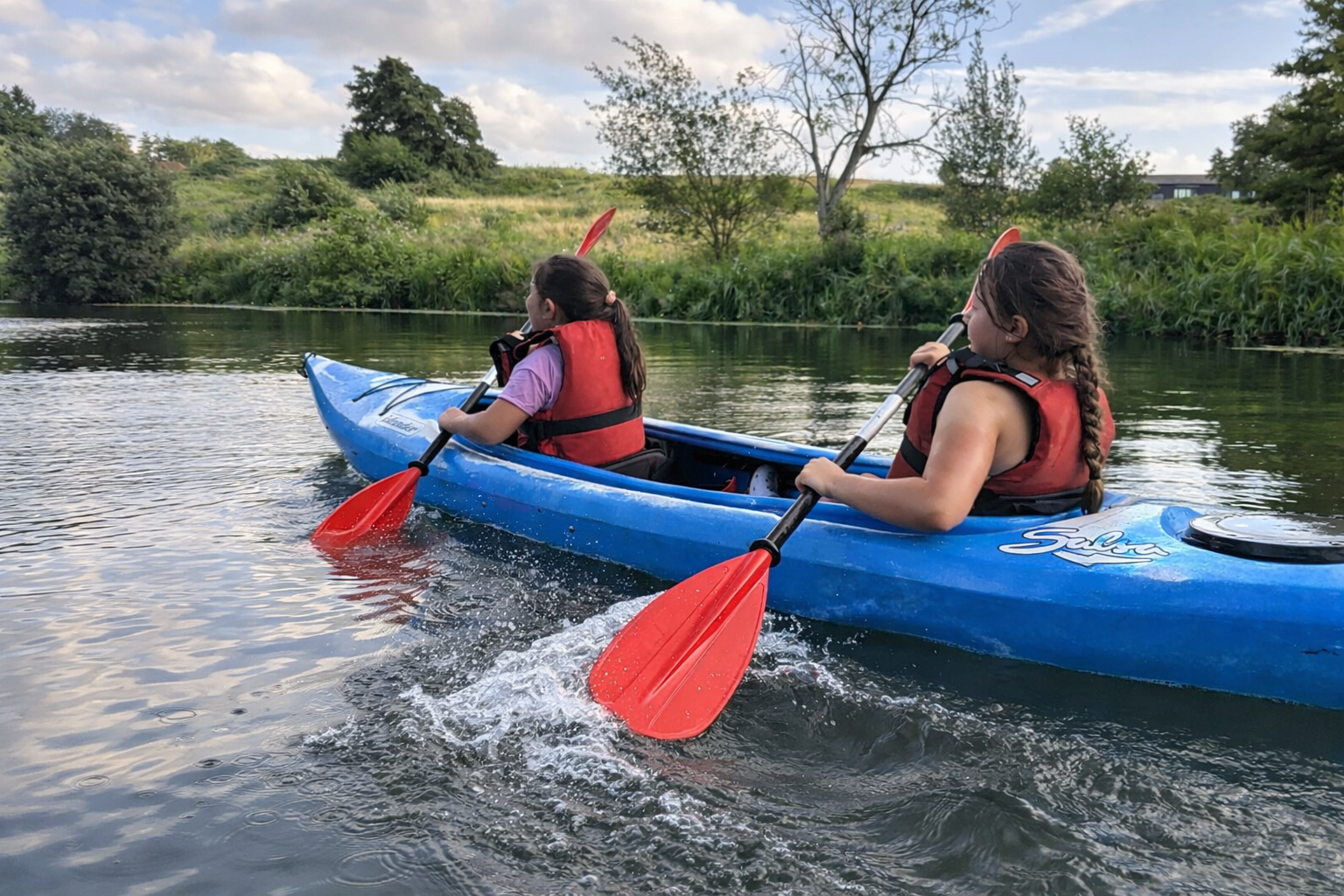 Kayaking adventure on a calm river.png