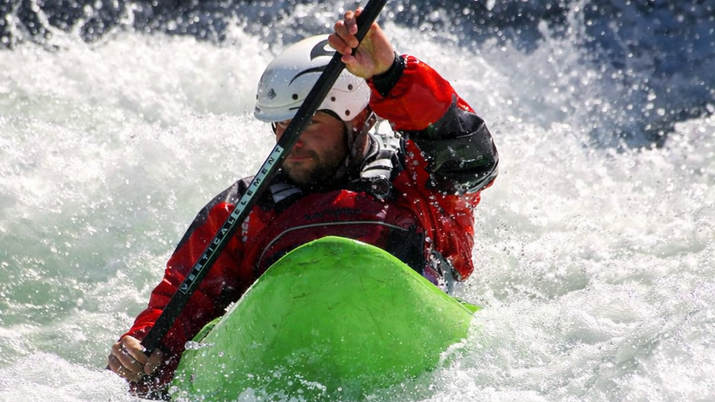Kayaker tackling whitewater rapids 2.png
