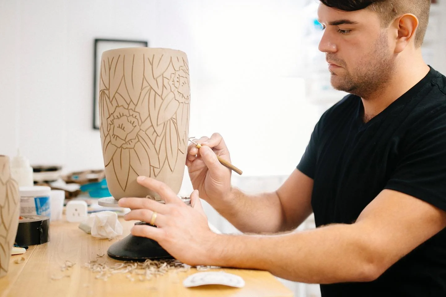 Carving a Rhododendron vase for @visitfallingwater. The last of a big new batch for them are cooling in the kiln now! 
.
.
.
Photo by @tatetullierphotography #artist #portrait #wip #process #creativeprocess #stoneware #me #pottery #porcelain #ceramic