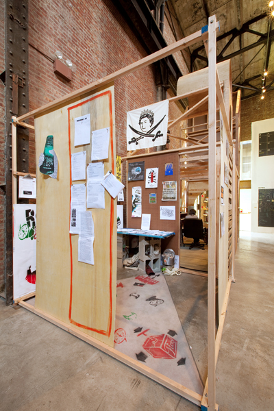   House Magic: Bureau of Foreign Correspondence Working Research Office ,  University of Trash , 2009, 96 x 96 x 96 in. wood, printed material, and videos. Produced by Alan Moore and the ABC No Rio Visual Arts collective. Photo: Jason Mandella    