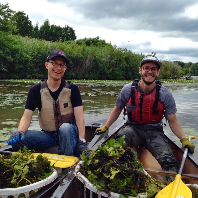 Volunteers remove water chestnuts from the Mystic River in Somerville.