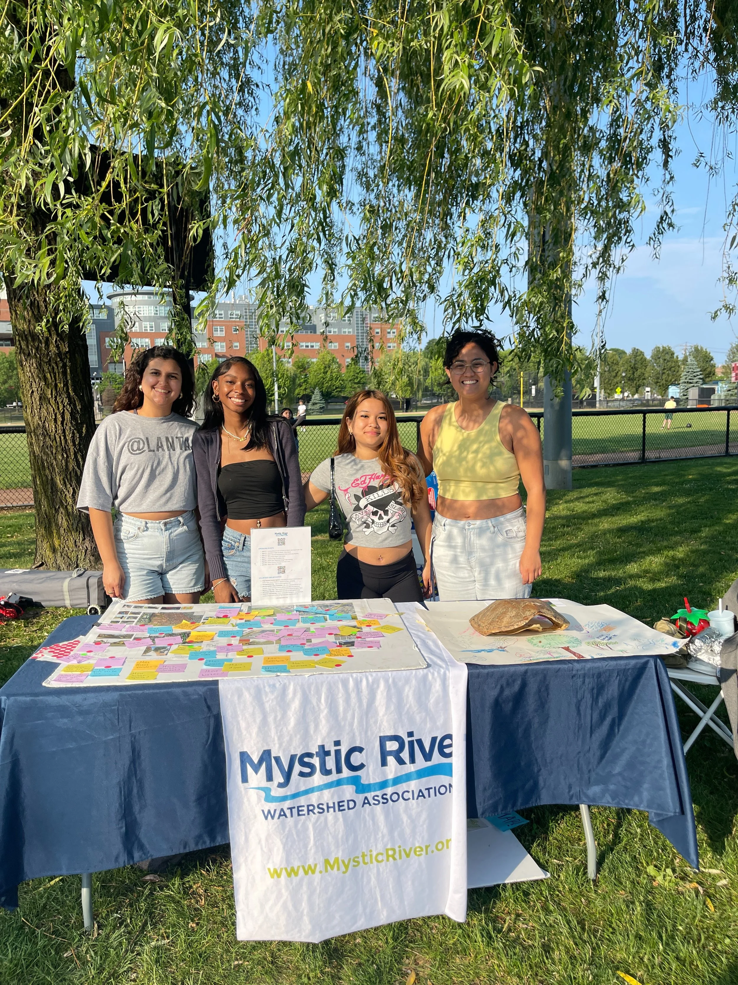 Climate leaders and MyRWA staff stand behind an outreach table.