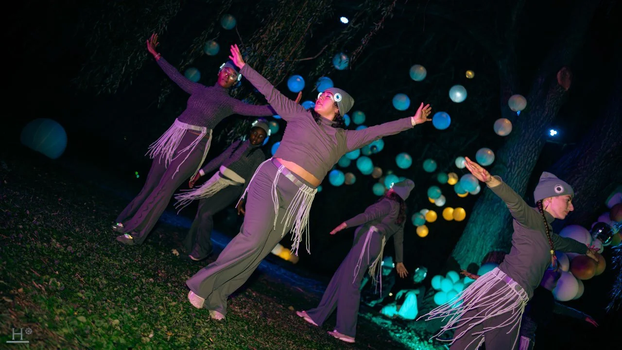 Dancers move in a circle while dressed in herring costumes.