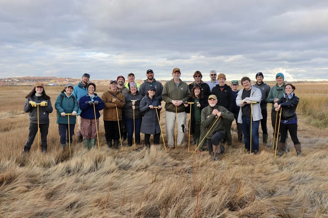 A group photo of workshop participants at the salt marsh.