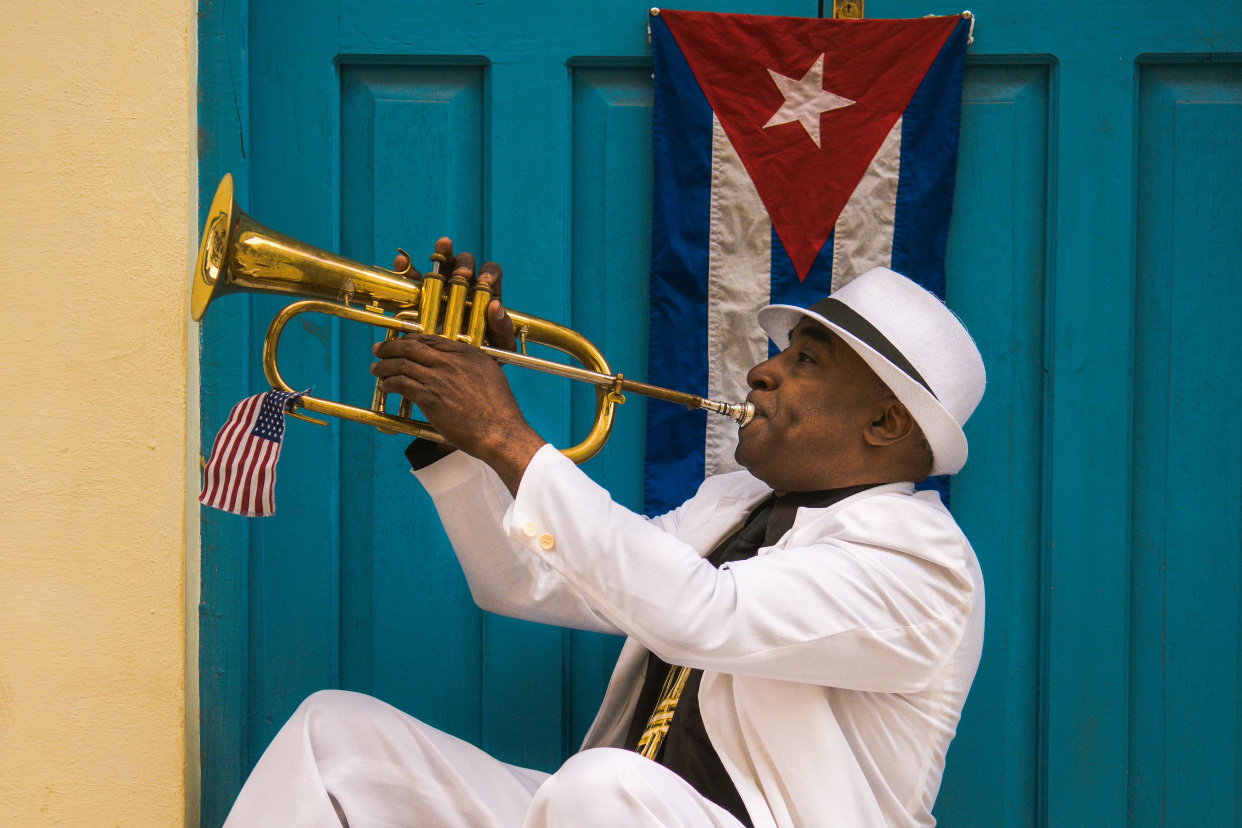 ISO 200 / 32mm / f2.8 / 1/800sec - Trumpet player on the streets of old Havana. Notice the American flag?