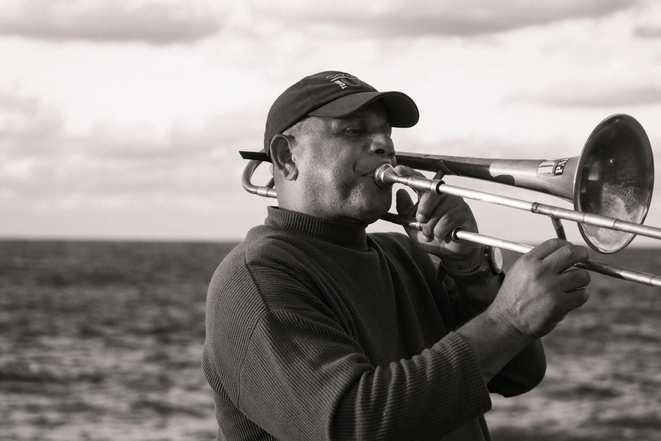 ISO 200 / 55mm / f3.5 / 1/500sec - On nice cool afternoons, the Malecon is full of tourists and local alike hanging along the seawall. Here is another trumpet player. 