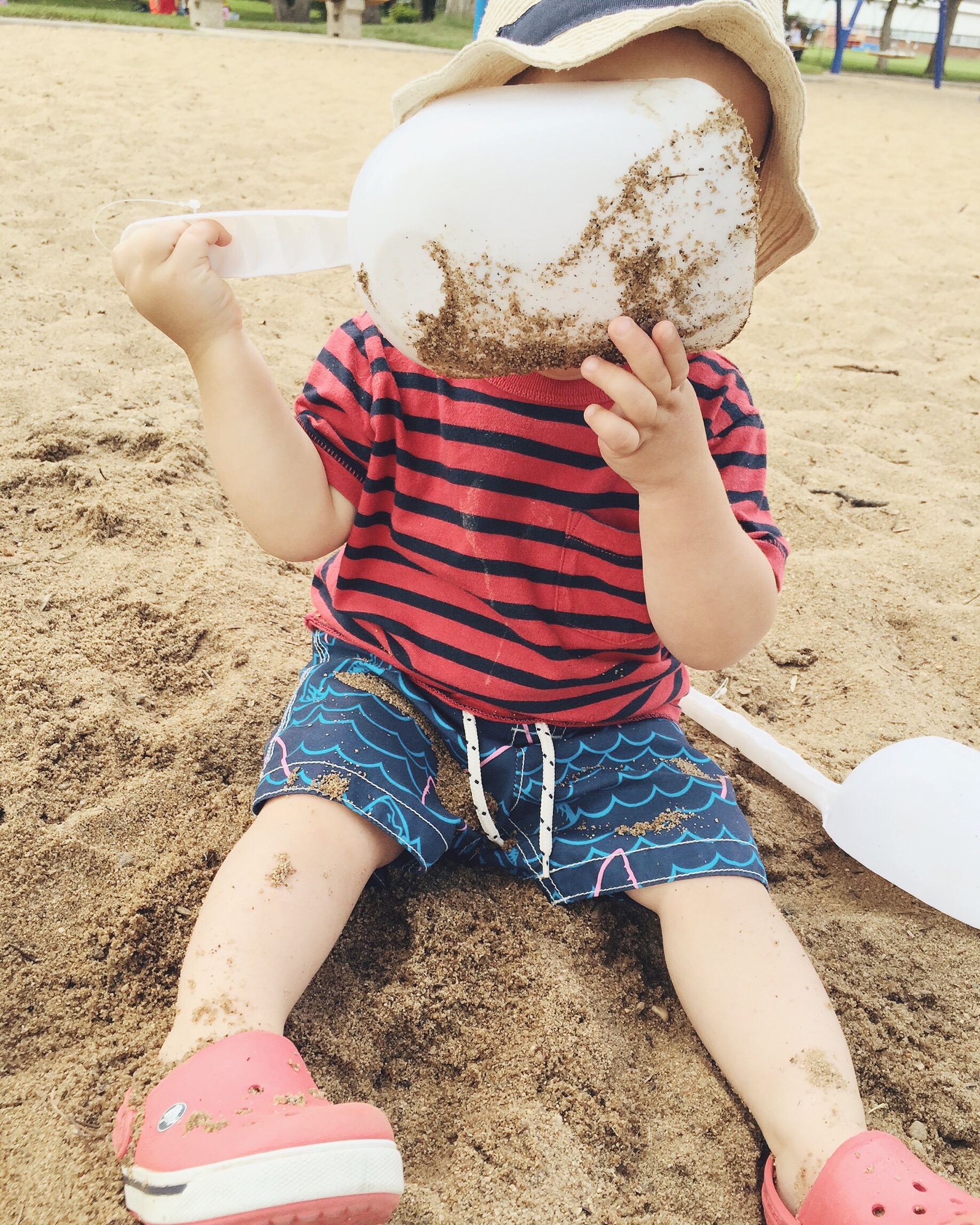 Eating sand since I forgot to bring a snack to the park. 