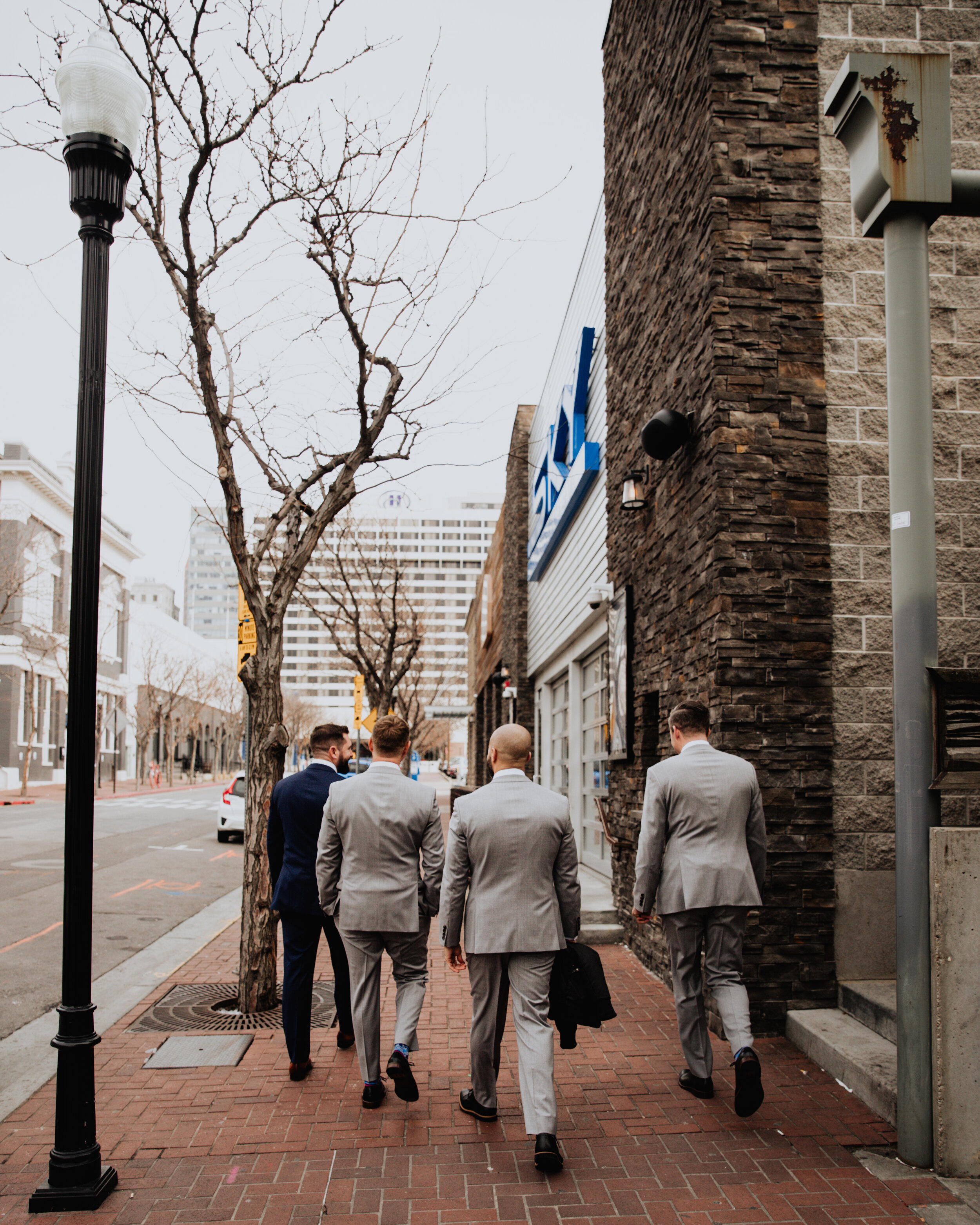 groom and groomsmen walking slc utah.jpg