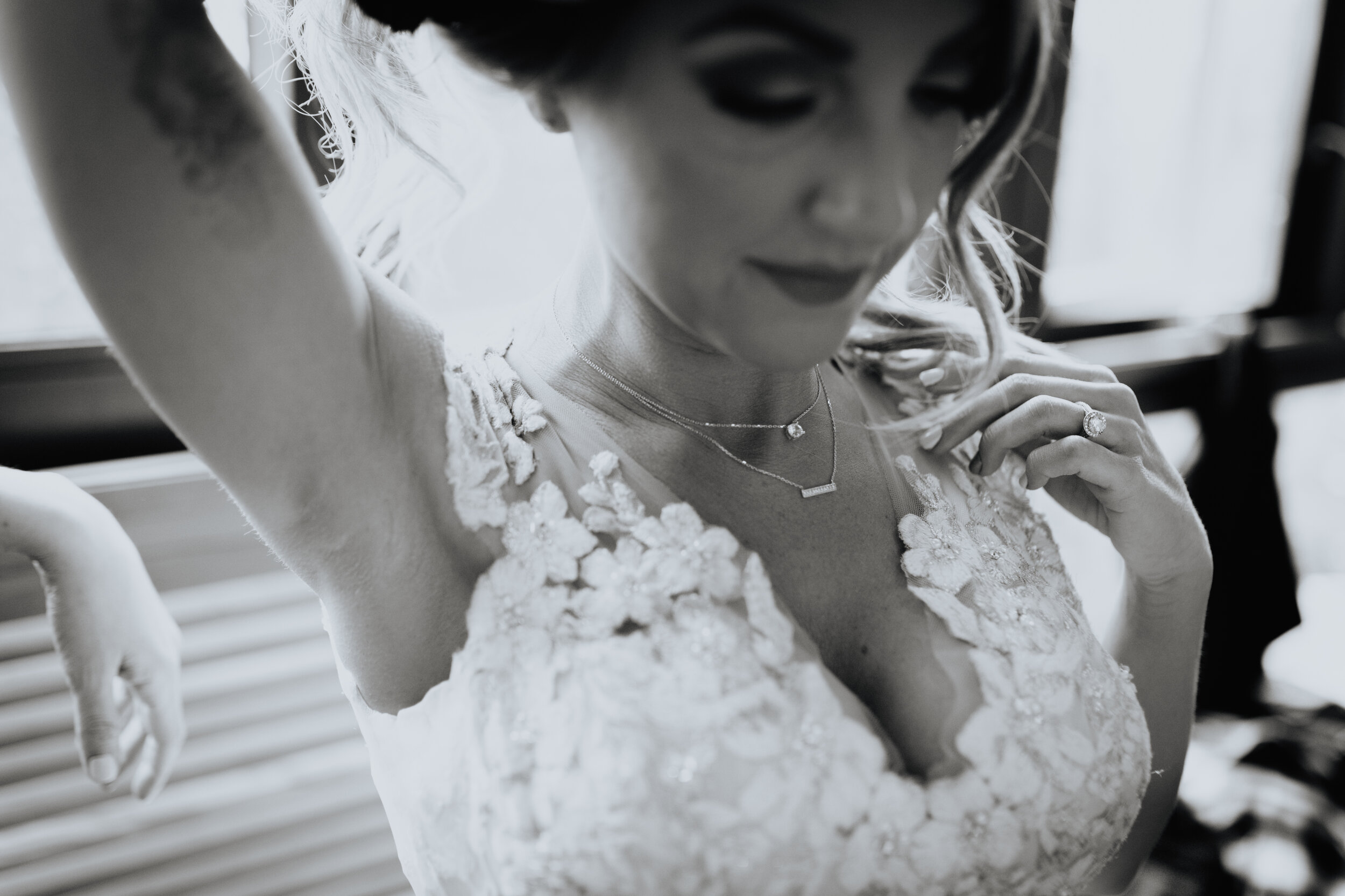 bride putting on jewelry.jpg