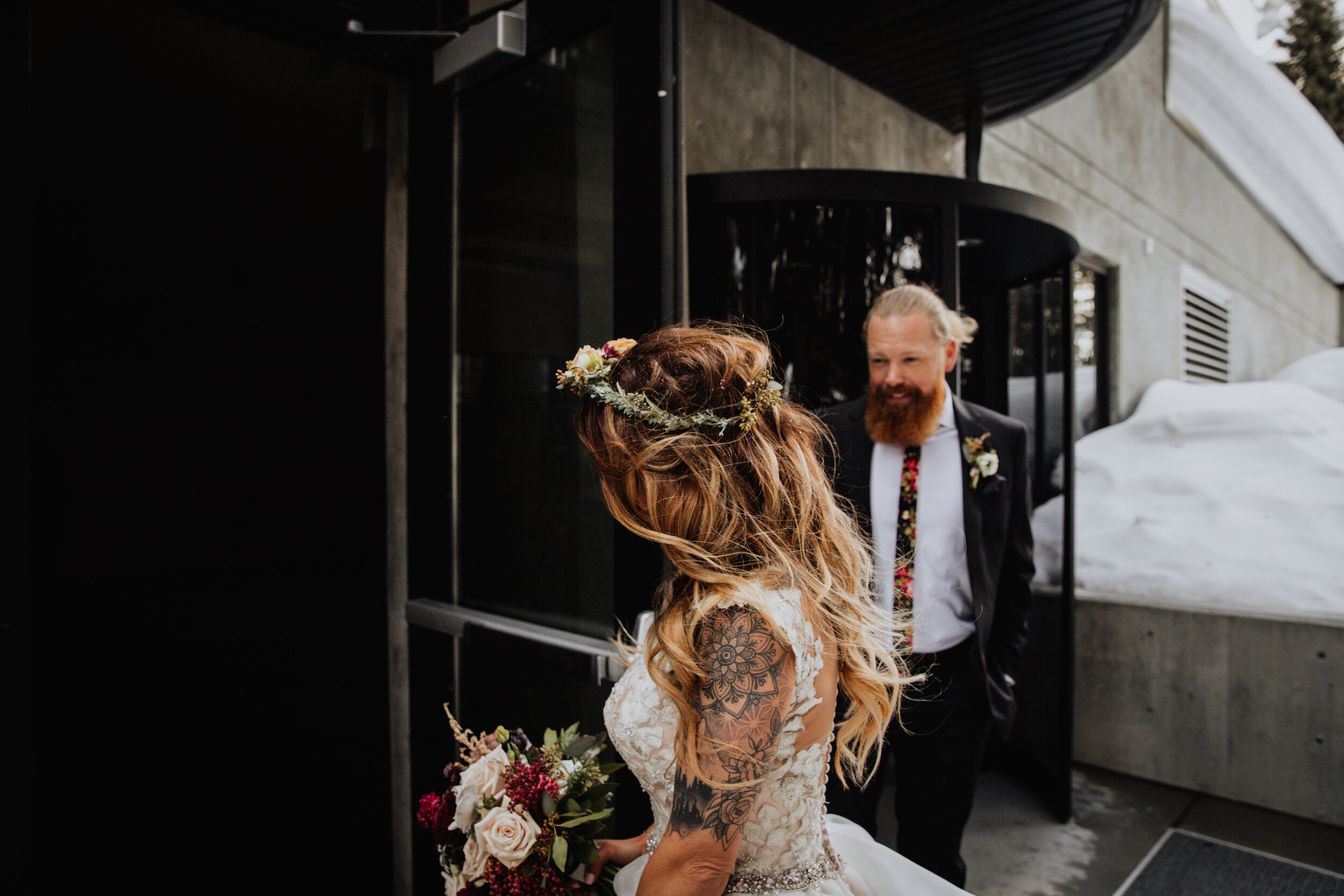 groom holding door for bride.jpg