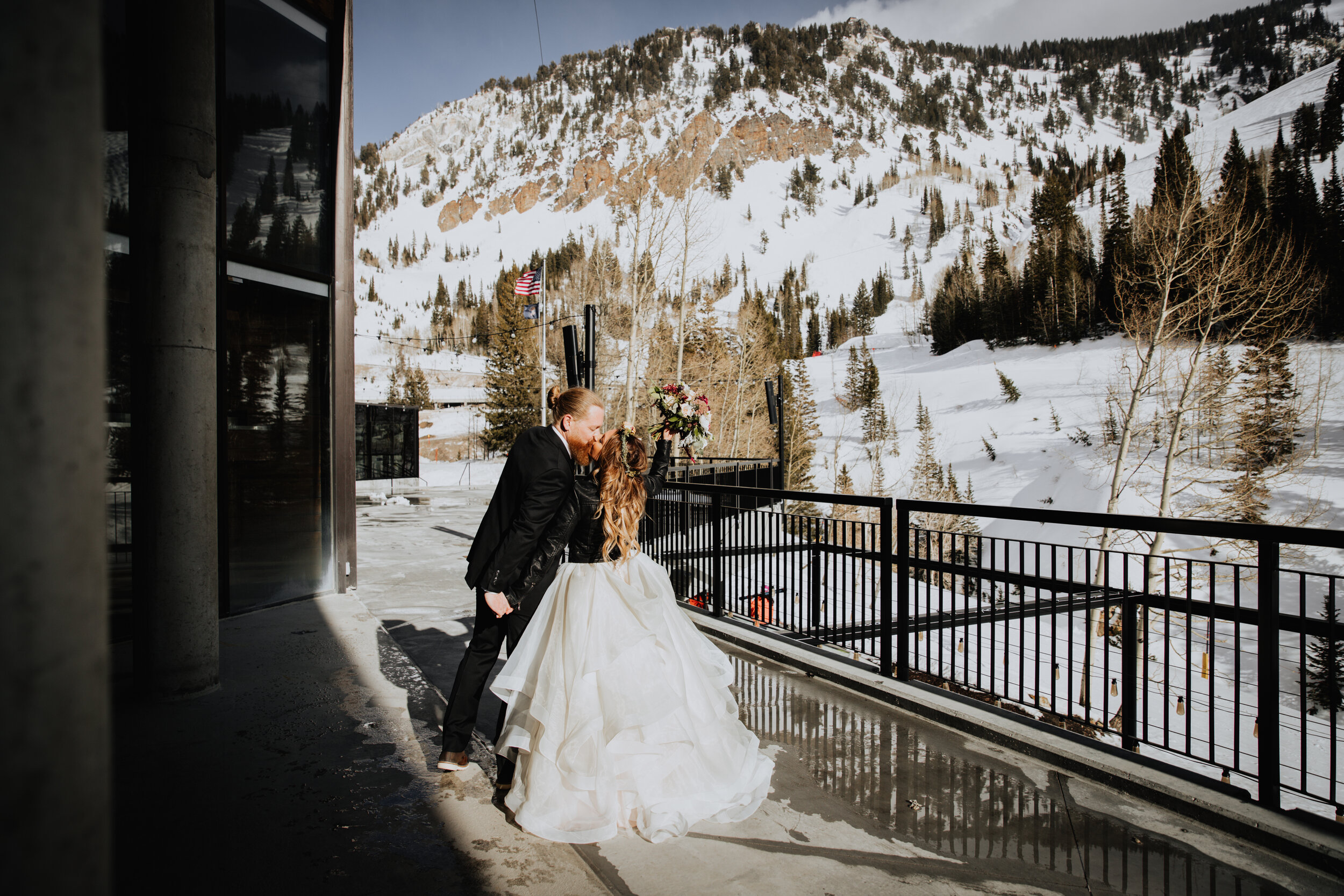bride and groom kissing outside near mountain.jpg