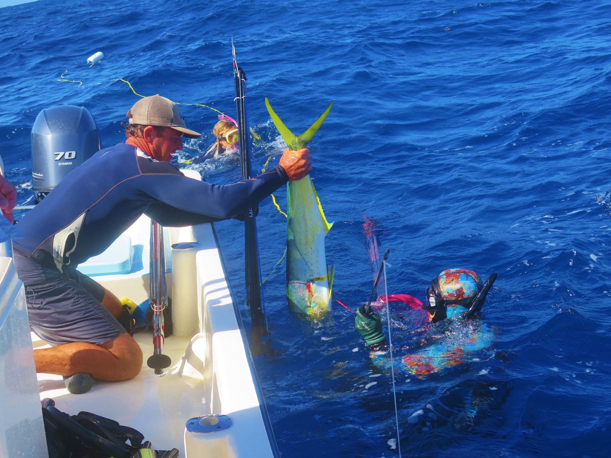 Adam bringing in his catch from the water