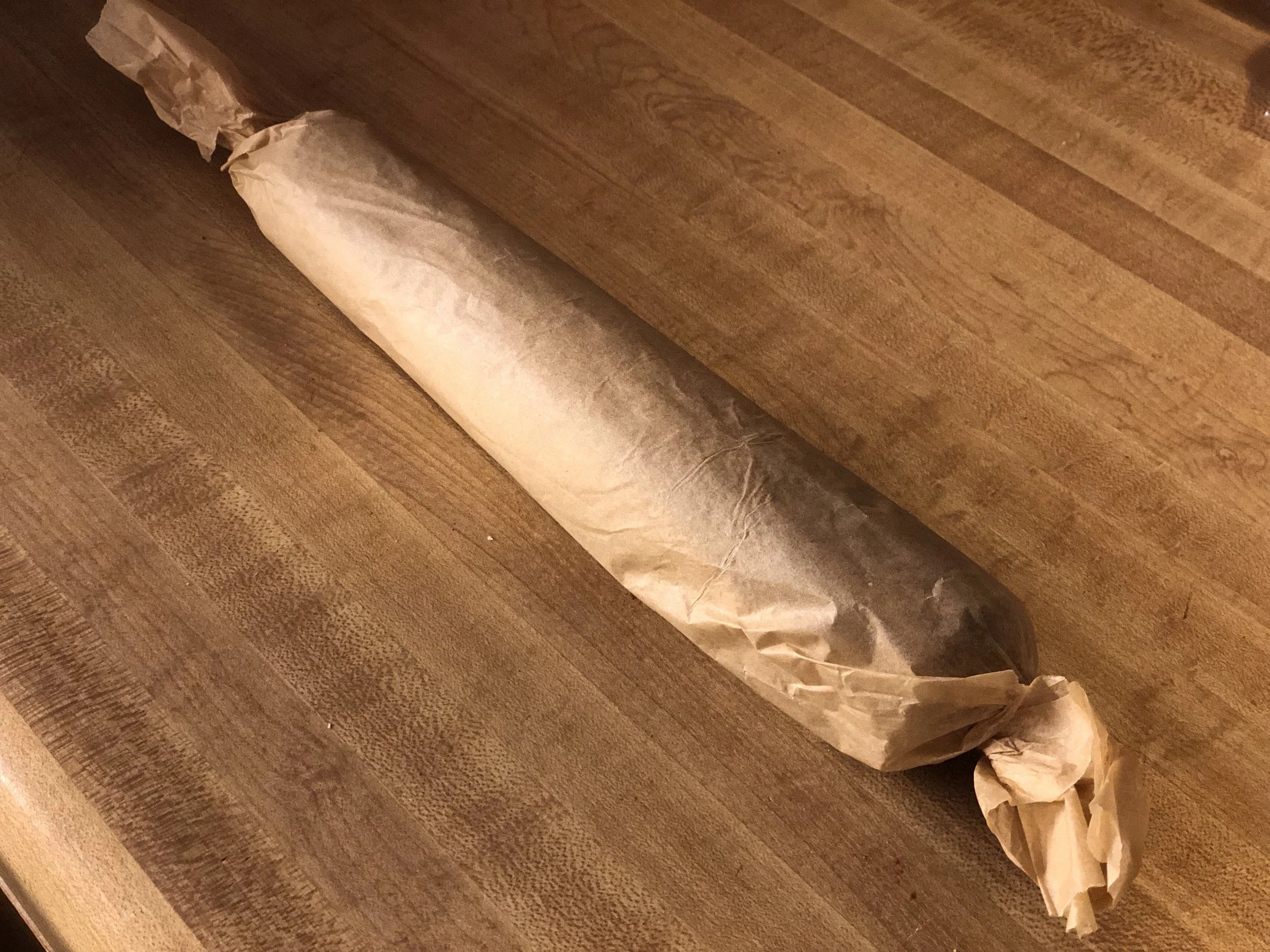 Roll the coconut log tightly with parchment paper and twist the ends. Place in the freezer 20-45min