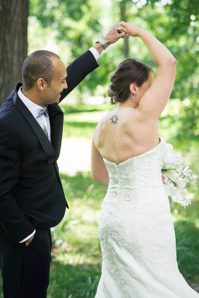 A portrait of a bride and groom during their first look in Tower Grove Park.