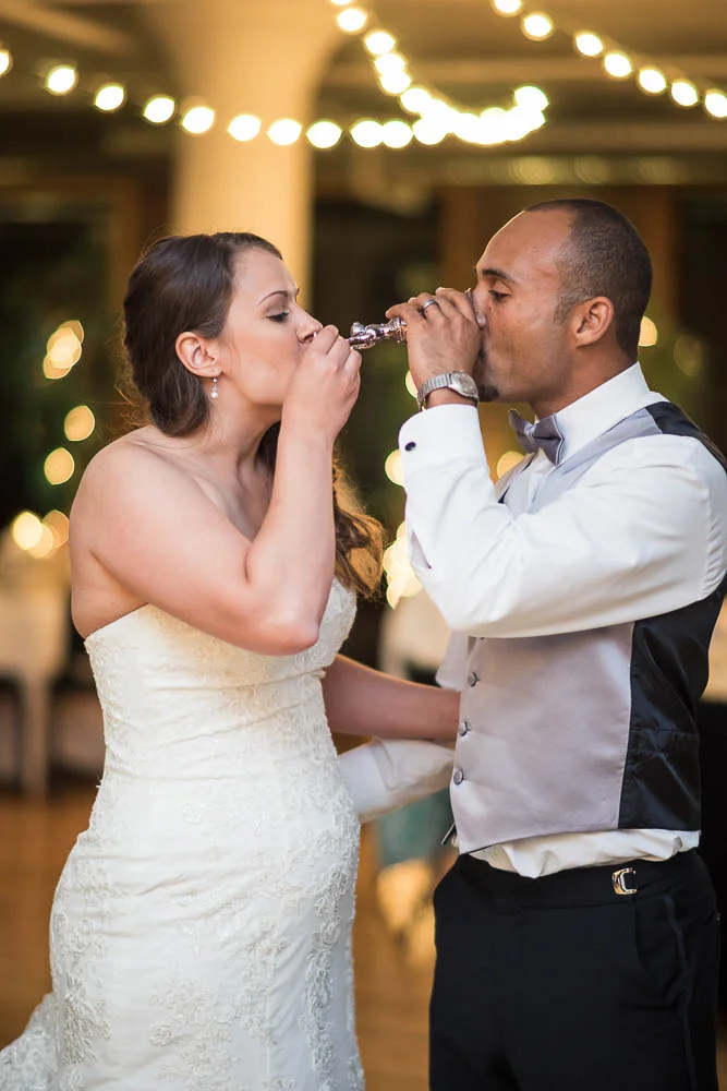 A bride and groom toasting during their wedding at Windows on Washington. 
