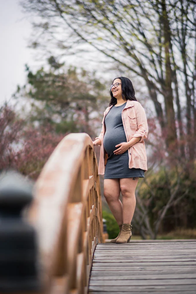 A natural light portrait of a pregnant mother posing during her maternity session. 