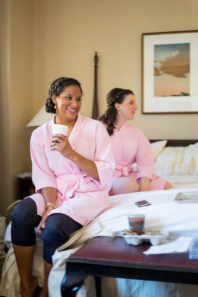 Bridesmaid's getting ready for a summer wedding in their hotel room.