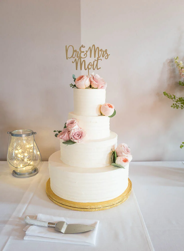 A picture of a bride and grooms cake before the cake cutting ceremony. 