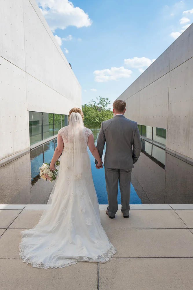 A portrait of a bride and groom posing at the Contemporary Art Museum. 