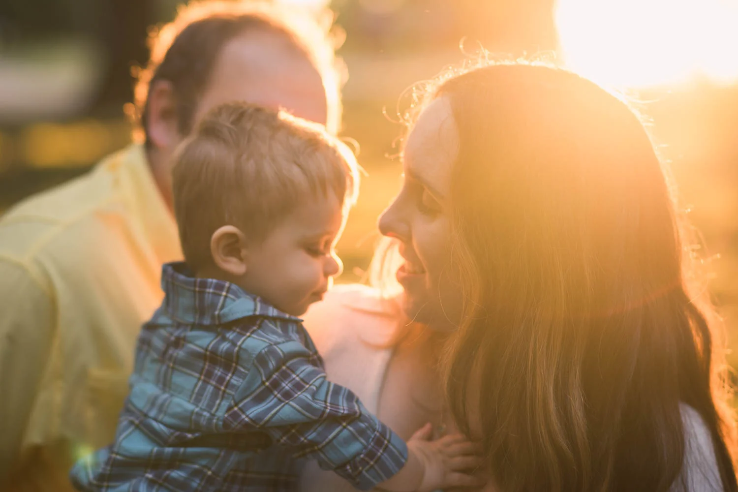 Golden hour portrait of a mother with her son during their fall family mini session in Tower Grove Park. 