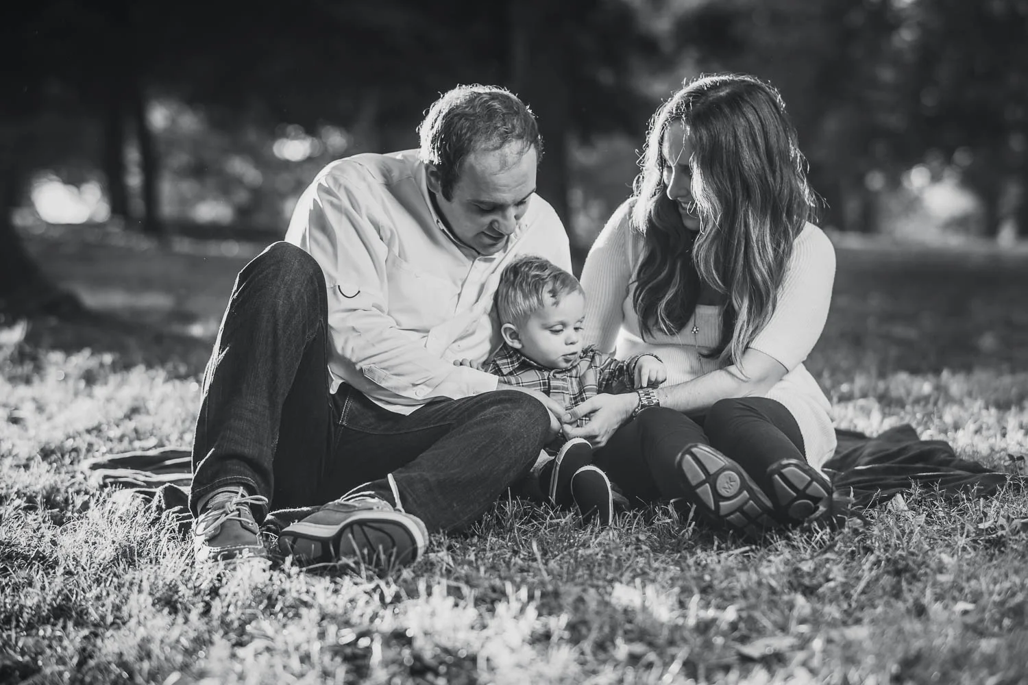 A family poses during a fall family photoshoot in Tower Grove Park. 