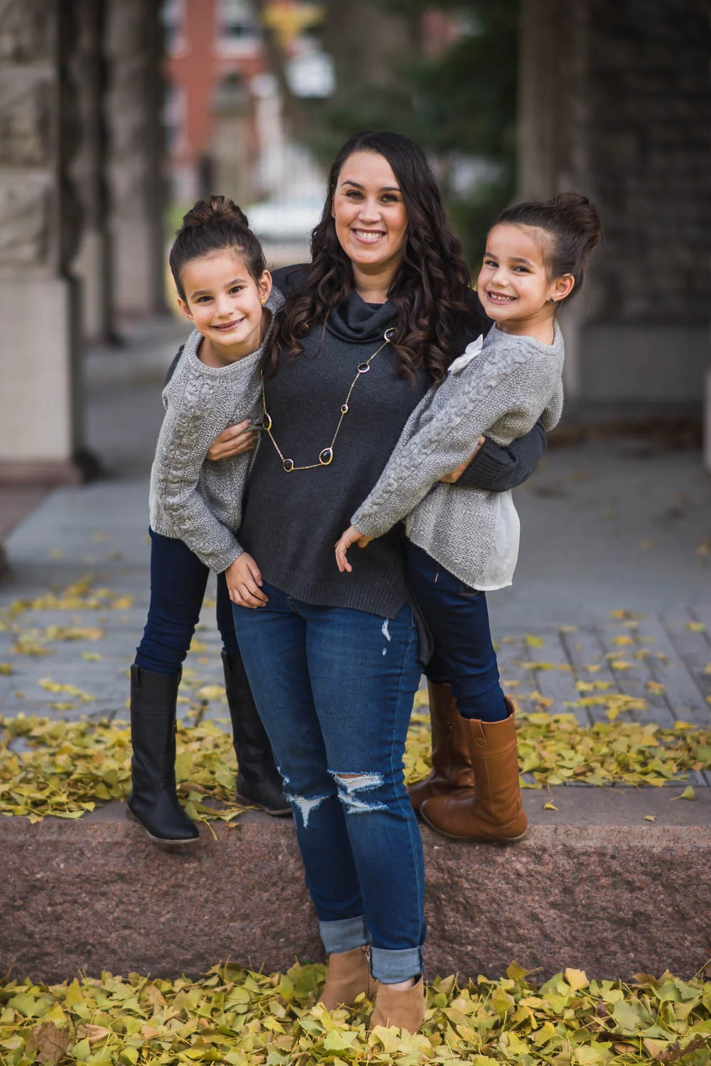 A family poses during a fall family photoshoot in Tower Grove Park.