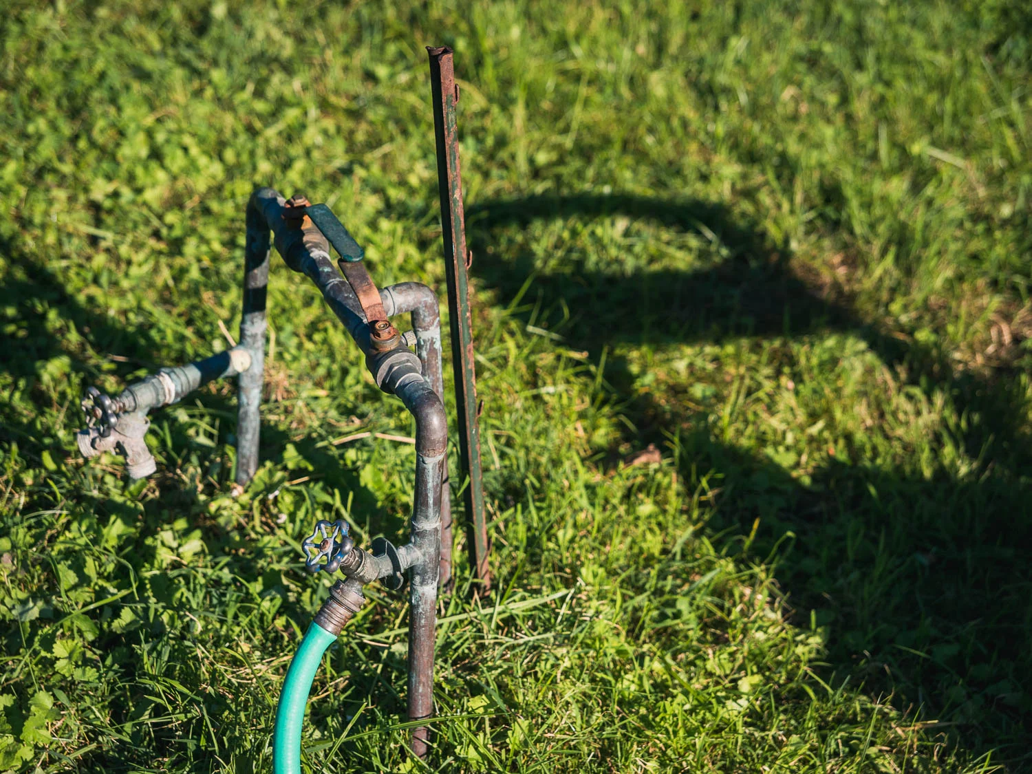 A watering hose connection located at the back of the garden. Water spigots are places throughout the garden for easy connection and watering.