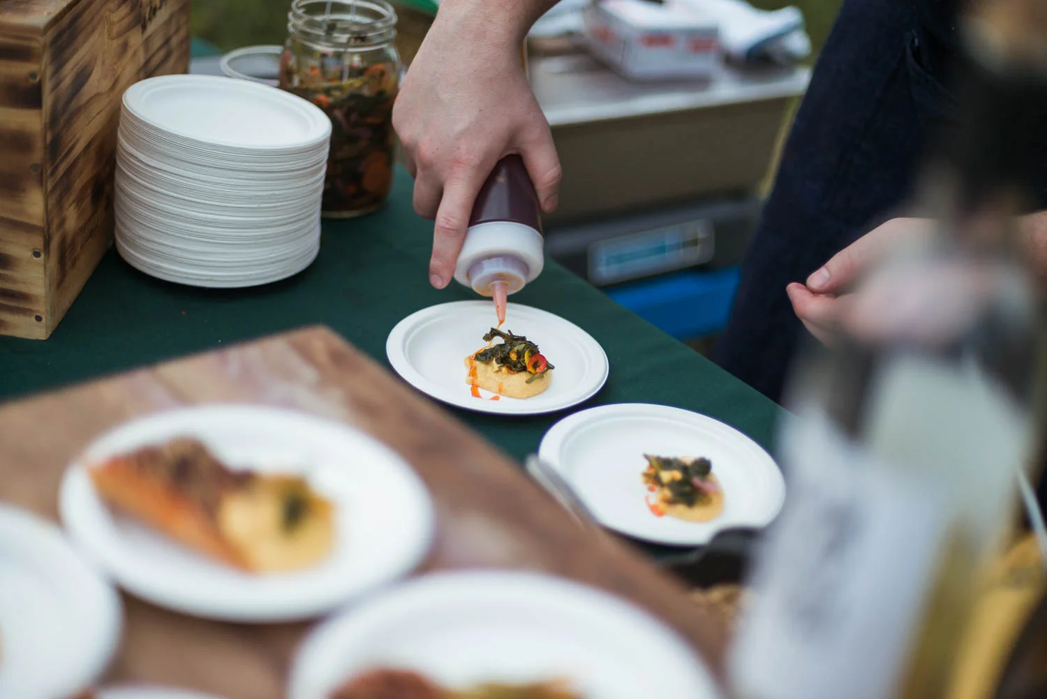 A chef preparing food for the annual Common Good City Farm Night on the Farm event.