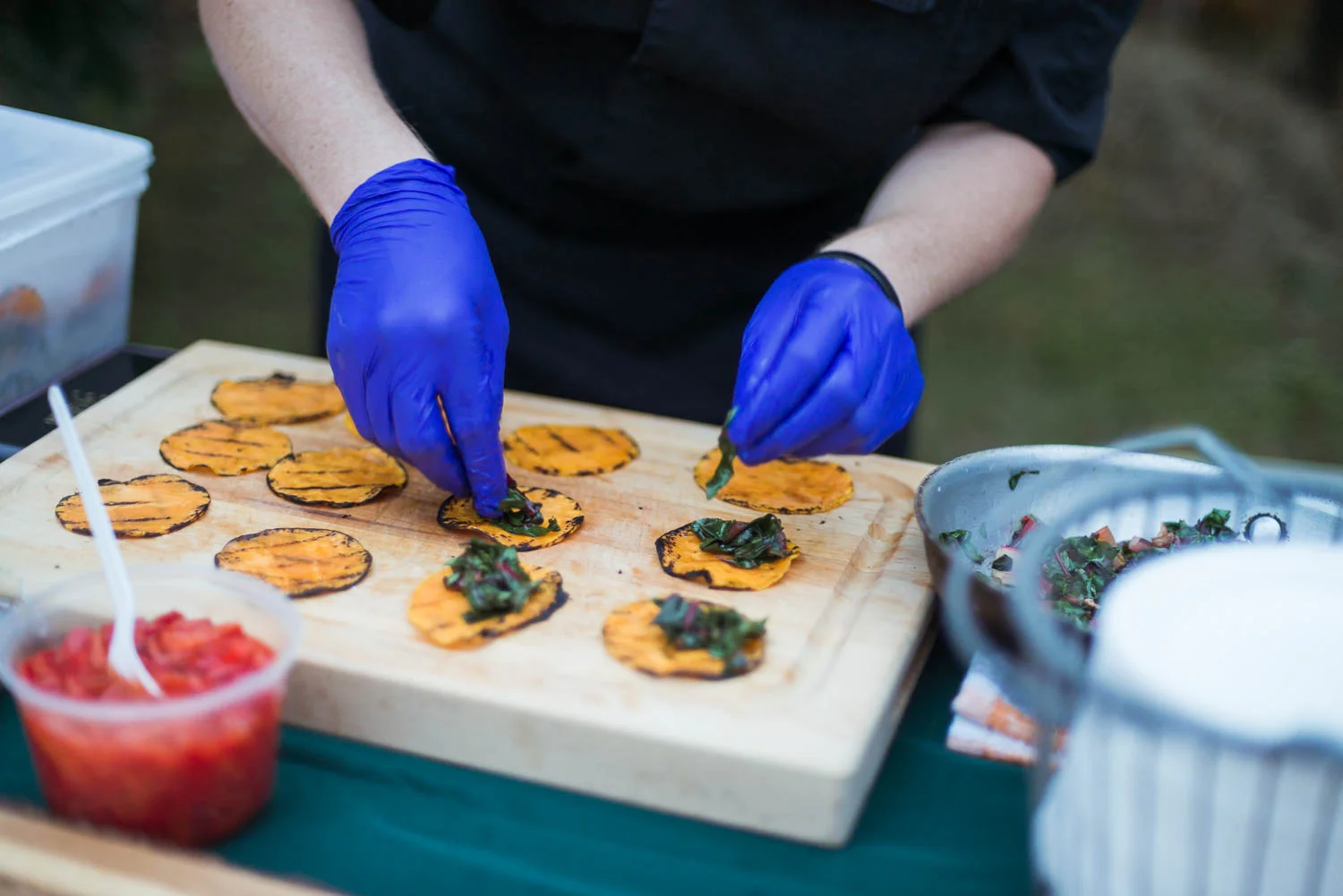 A chef prepares tacos for the annual Common Good City Farm Night on the Farm event.