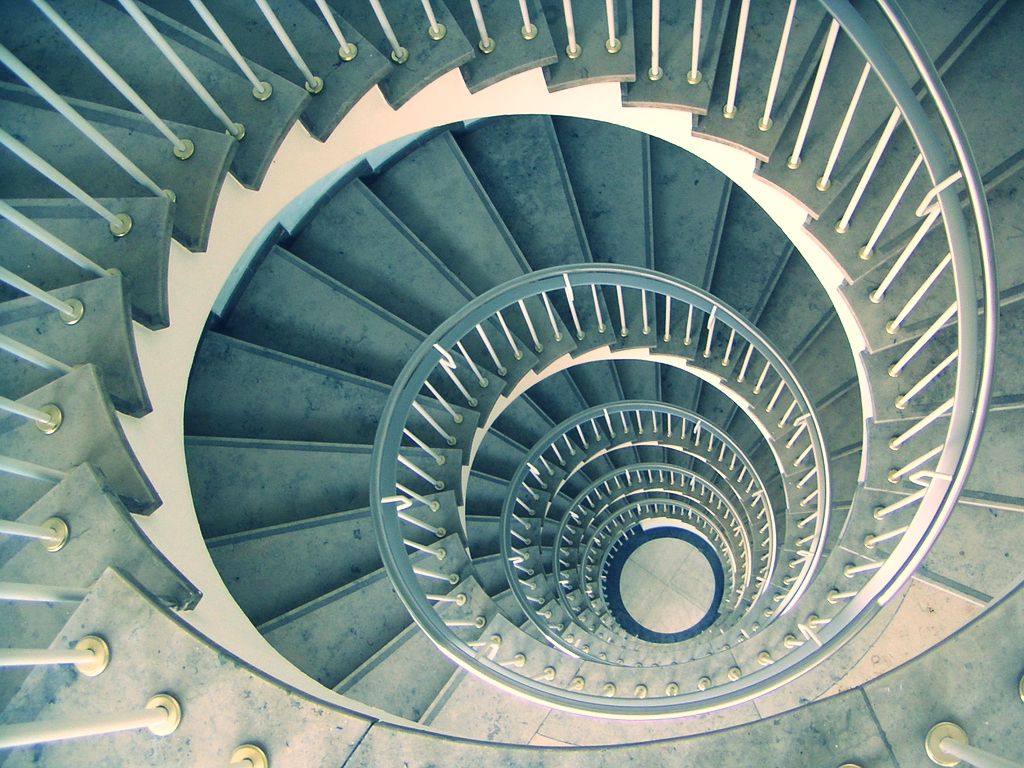 This staircase is a good illustration of a spiral curriculum. As a person walks up, the circular design causes them to revisit the same part of the structure that they had previously been to, but each time they are one level higher.