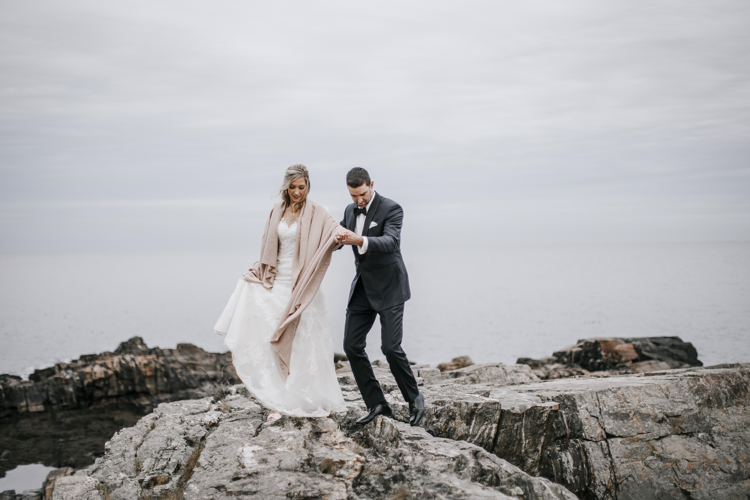 a bride and groom near the water at Cliff House, Maine