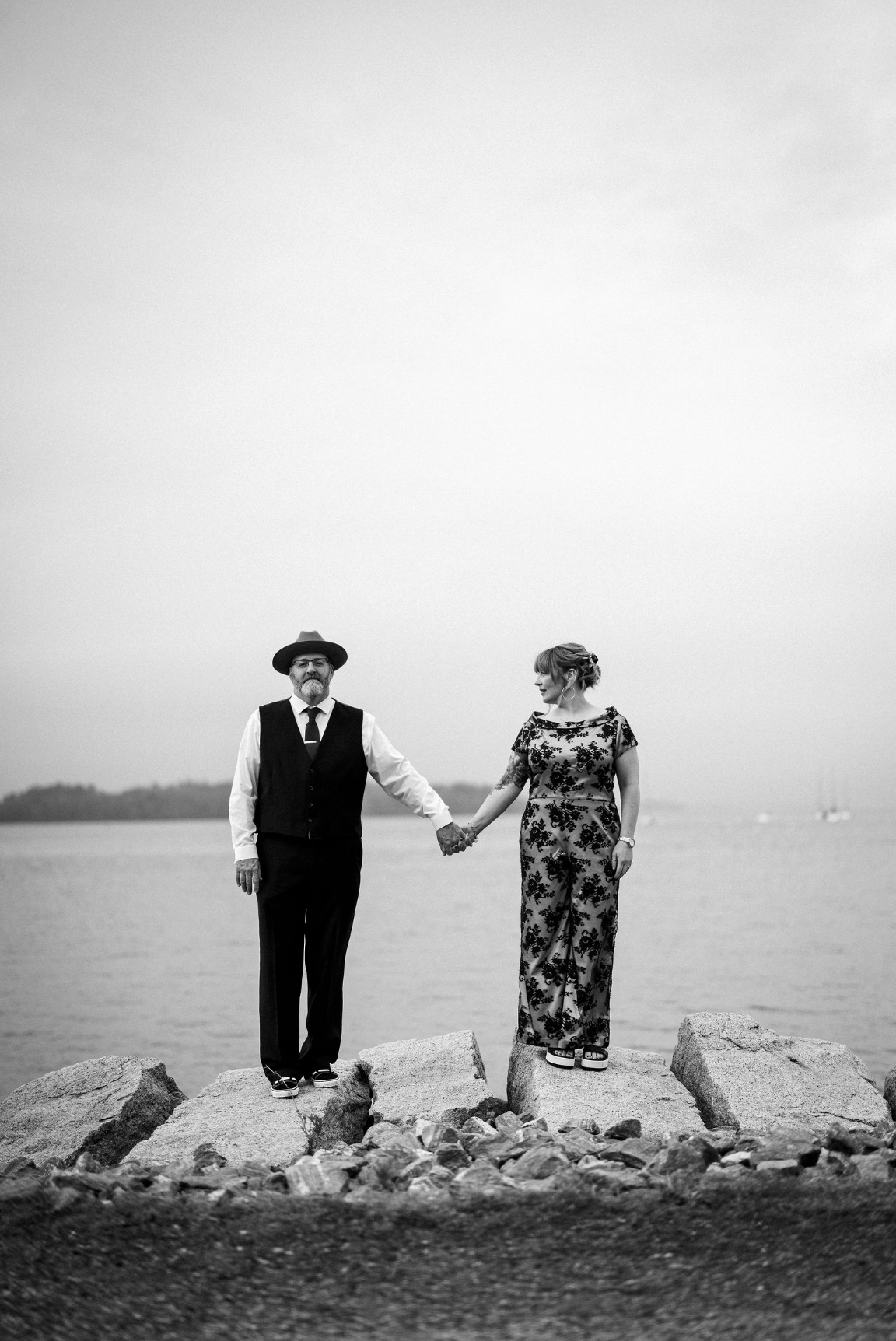 Couple stands on rocks during their elopement in Portland, Maine