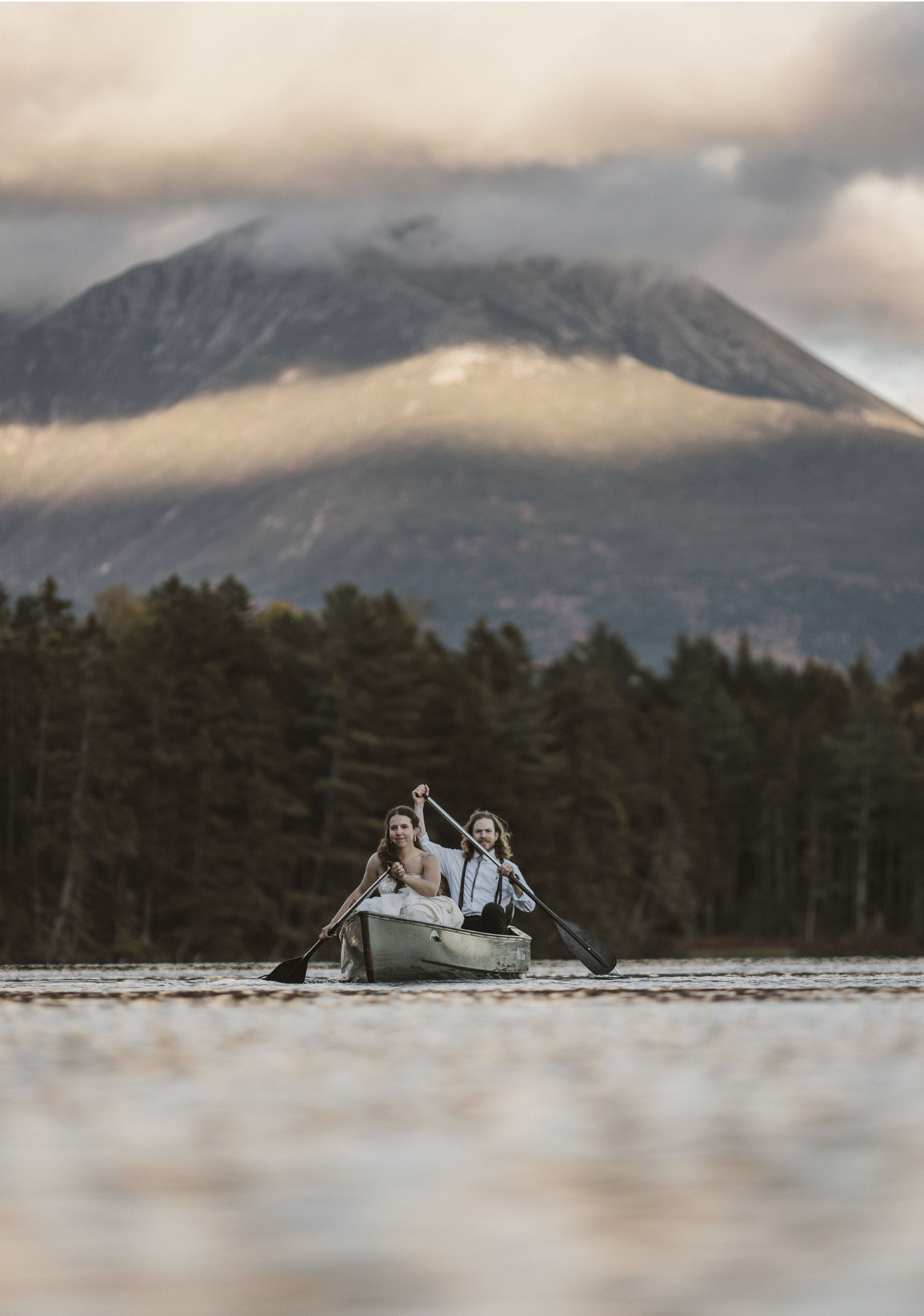 Newlywed couple paddles canoe during their elopement in Baxter State Park