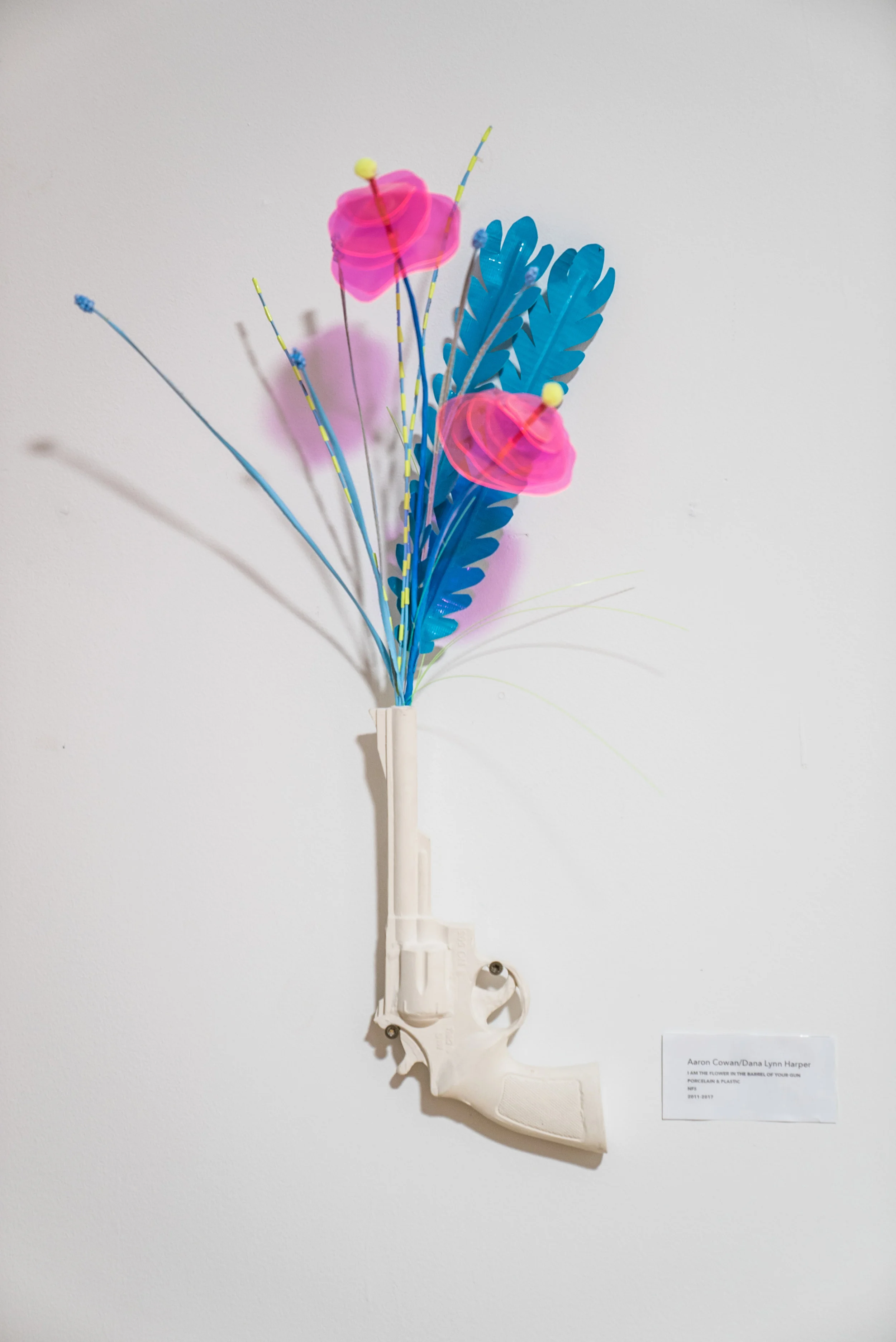 I am the Flower in the Barrel of Your Gun, slip-cast porcelain pistol, plastic, tape, collaboration with Dana Lynn Harper