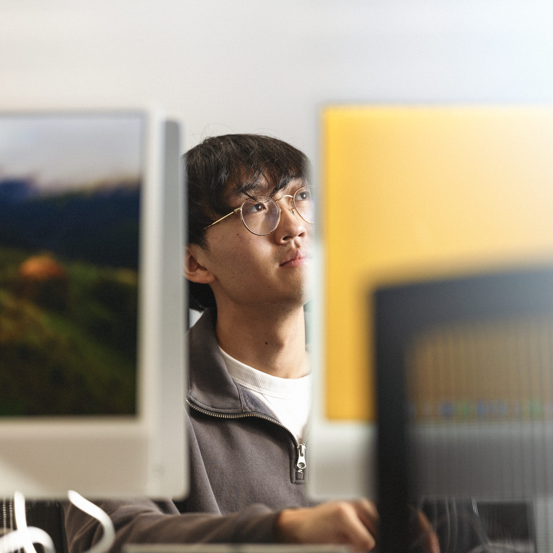 student at a computer thinking