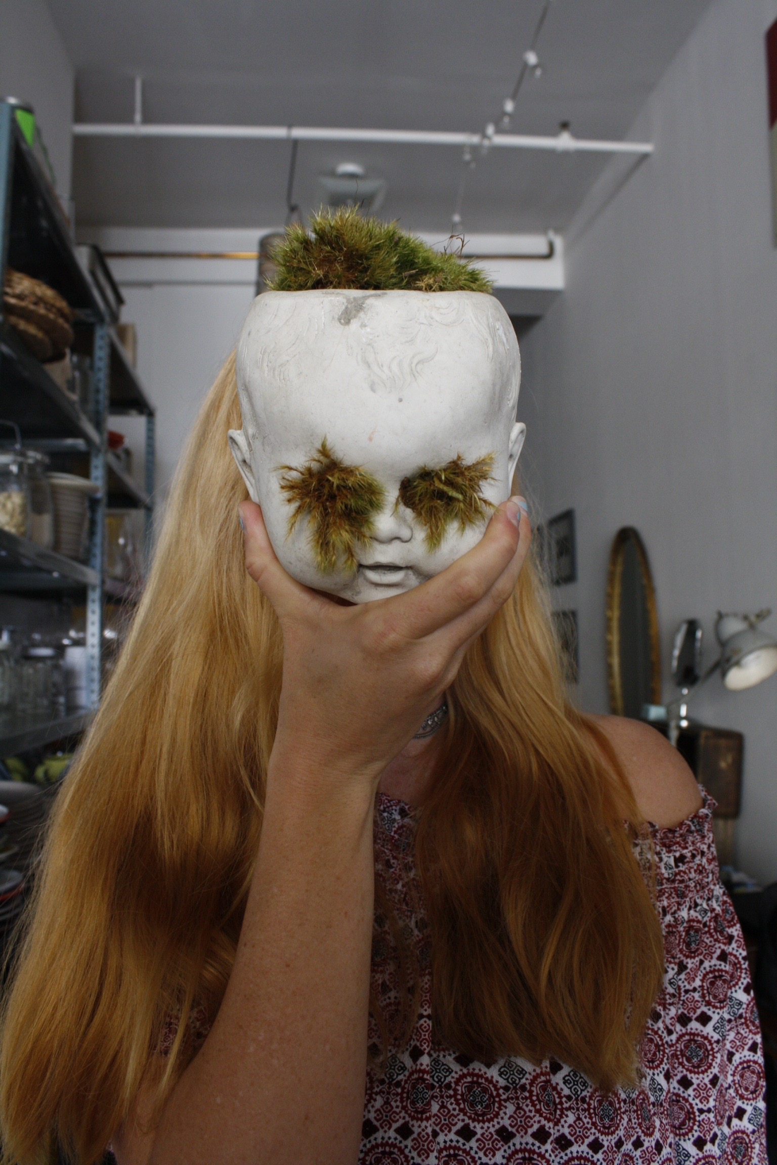 A creepy but endearing doll face with plant features. 