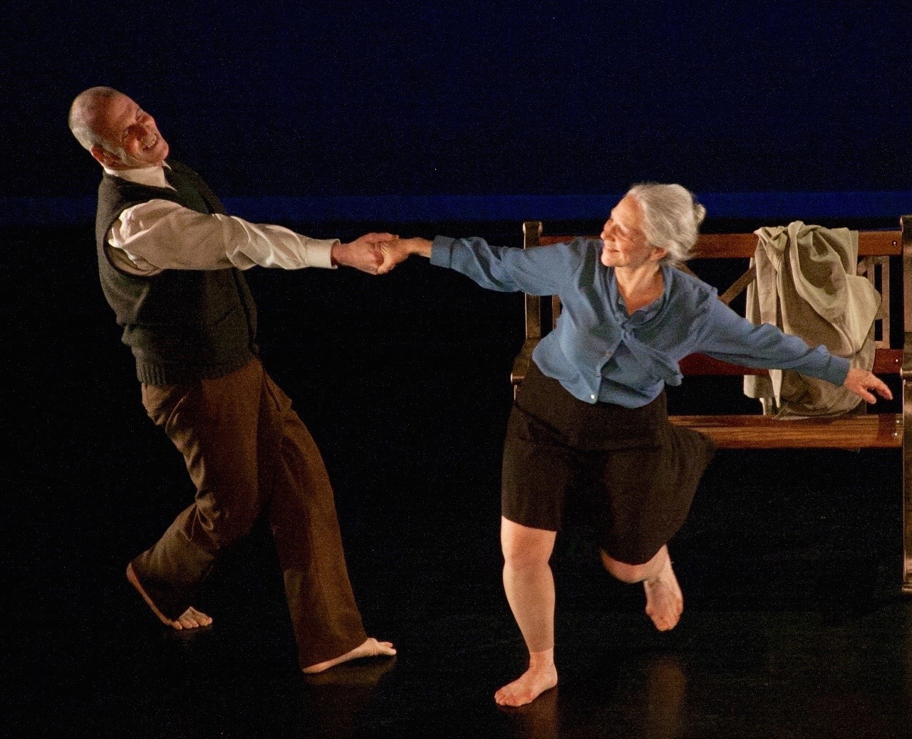 Thomas Sullivan and Sara Schwabacher (Photo Nicole Bennett). (Smiling male and female dancer hold hands and reach way from each other as woman swirls around.)