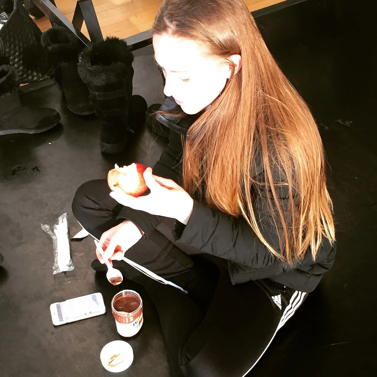 Dancer Maddie eating an apple and Nutella during a rehearsal break.